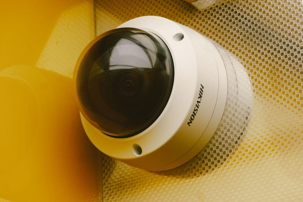 A Hikvision dome CCTV camera mounted on a wall