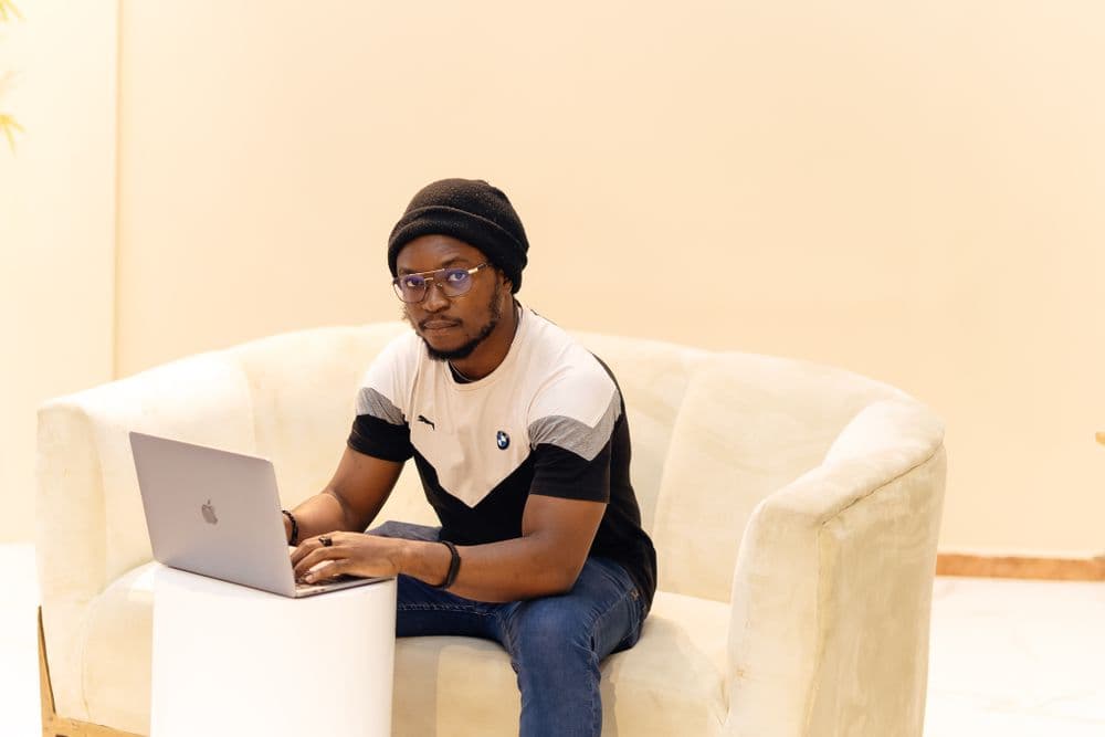 A Nigerian developer building on a laptop